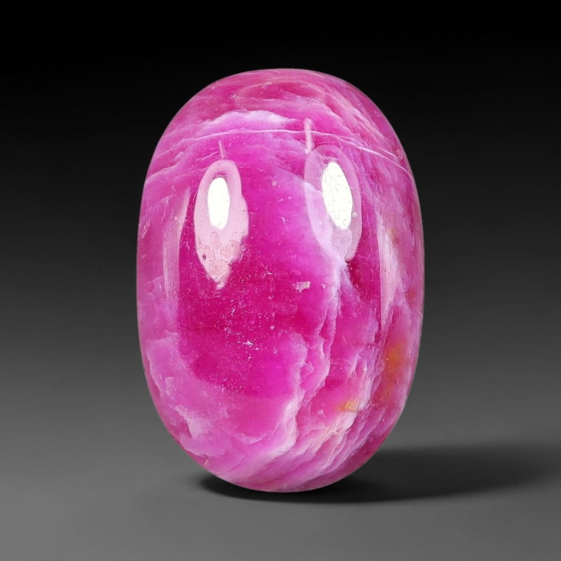 11.66 Carats Natural Mozambique Vivid Pink Red Ruby Loose Gemstone, 85FG: This polished Mozambique ruby cabochon measures 16.4x11.1x5.5mm, featuring striking natural swirling white mineral banding layered across a rich saturated pink red base that creates a unique organic a