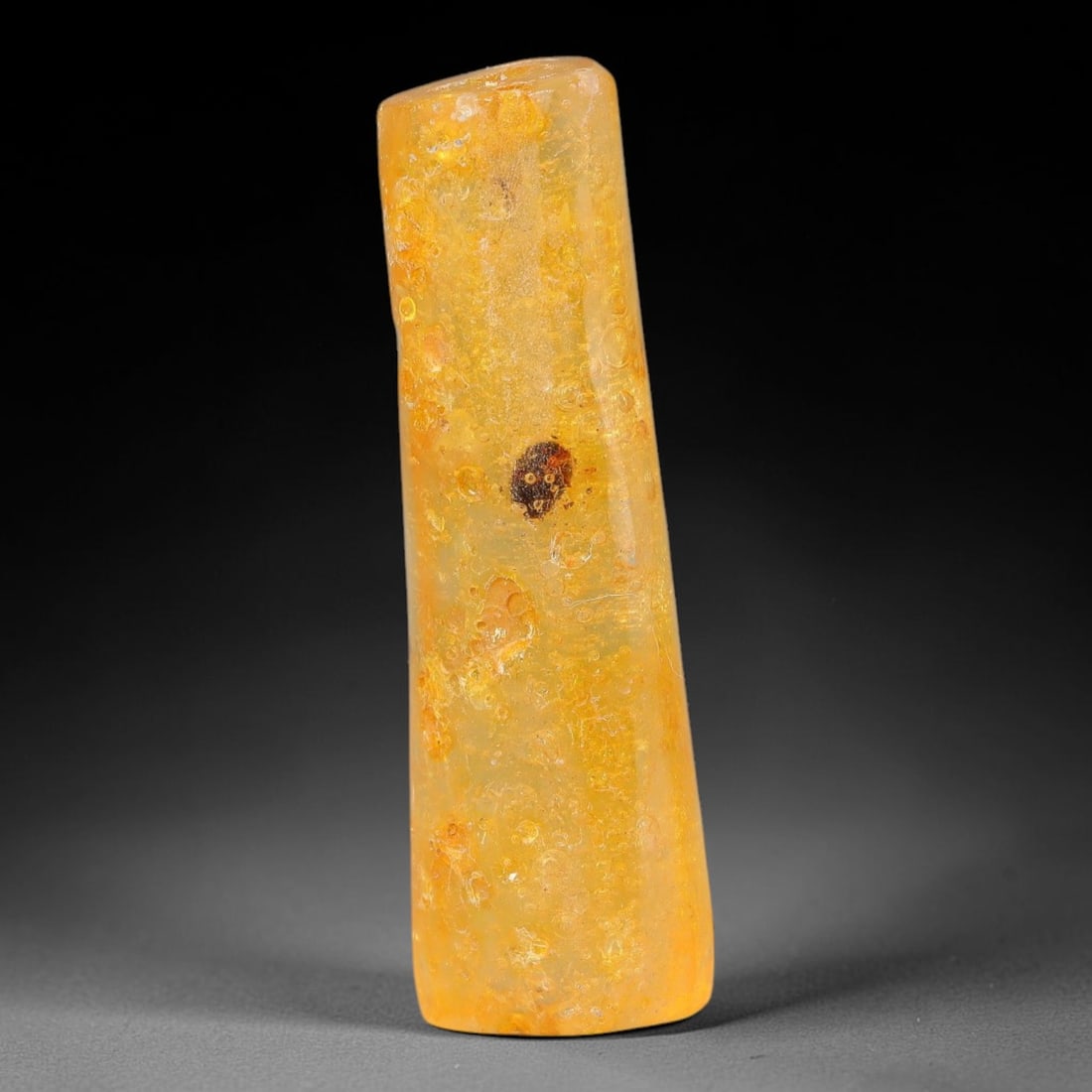 19.18ct Natural Baltic Polished Loose Freeform Amber Gemstone, 42EB: This smoothly polished freeform amber piece carries warm translucent organic clarity with fine natural fossil flecks and tiny mineral inclusions suspended throughout its 39x12mm flowing unstructured s