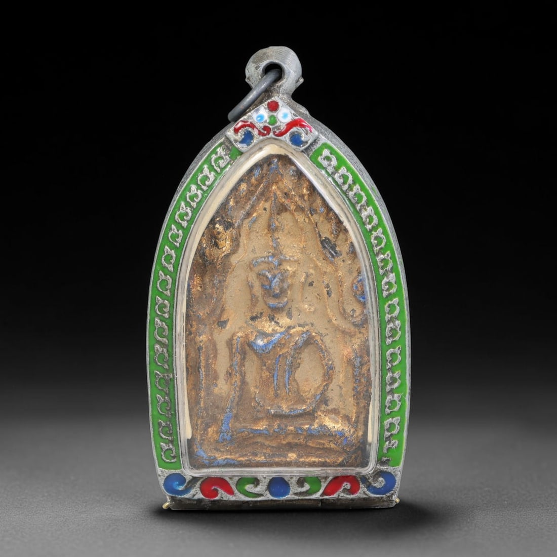 Thai Buddhist Folk Tradition Enclosed Amulet Pendant with Decorative Metal Casing, 26AH: This Thai sacred amulet is housed within an ornate hinged metal protective casing fitted with a top loop for wear as a pendant. The casing features intricate embossed surface detailing and a continuou