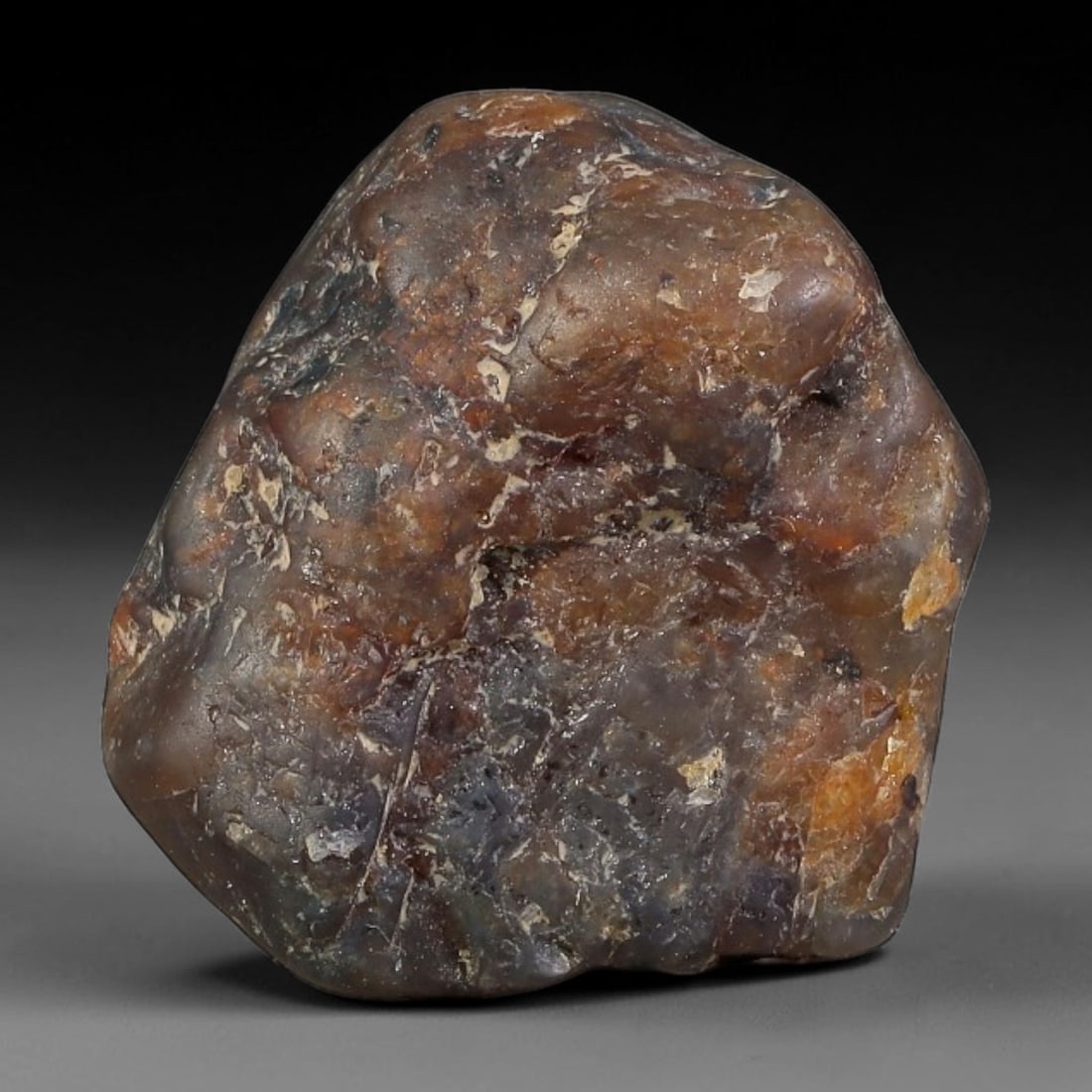 26.23ct Natural Unheated Sri Lankan Purplish Blue Sapphire Rough, 82FC: This natural corundum rough is an unheated purplish blue sapphire sourced from Sri Lankan alluvial gem deposits, featuring an irregular natural native form with residual pale yellow-brown mineral matr