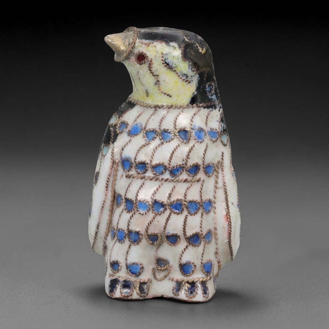 A Chinese Cloisonne Enamel Penguin Effigy, 96FG: Constructed from a copper alloy body and decorated with cloisonne enamel, the object is formed as a standing penguin with an upright posture and the head turned slightly upward. Fine metal wire cloiso
