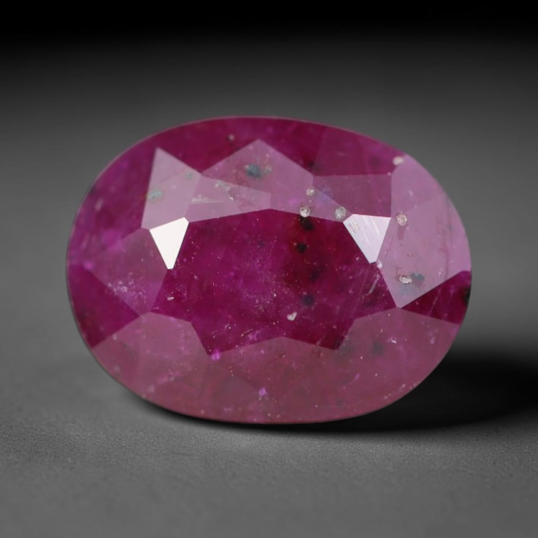 1.32ct Natural Tanzanian Longido Deep Crimson Red Faceted Ruby Loose Gemstone, 76BC: This expertly faceted Longido ruby features a rich deep crimson red body tone with distinct natural linear mineral striations, scattered pale mineral deposits and minor dark mineral flecks visible wit