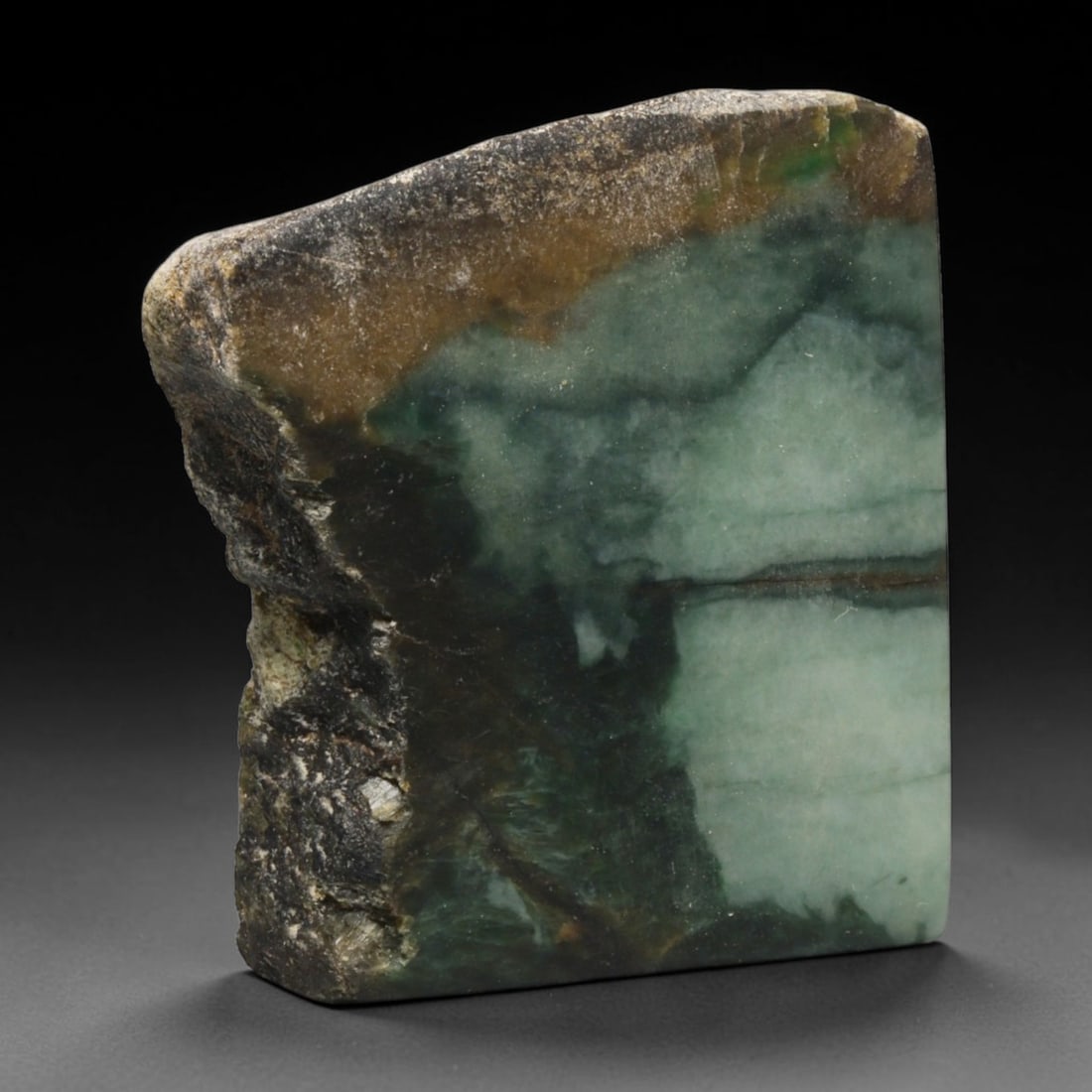 255ct Natural Type A Burmese Jadeite Jade Sliced Rough, 90EF: This specimen is a sliced rough block of natural Type A Burmese jadeite jade. The interior displays natural colour zoning with visible mineral veining and crystalline patterns typical of unprocessed j