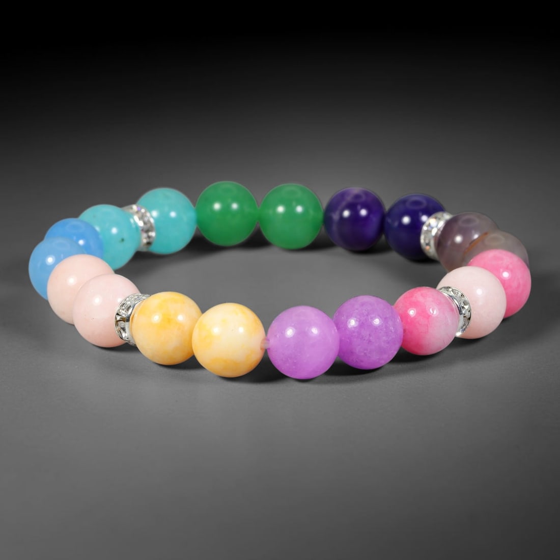 Natural Multi-Colored Quartz Beaded Bracelet, 27FJ: Beautiful bracelet crafted with polished natural quartz round beads, complemented by decorative silver spacer accents. Smooth 10mm beads display a vibrant spectrum of natural tones, arranged into a fl