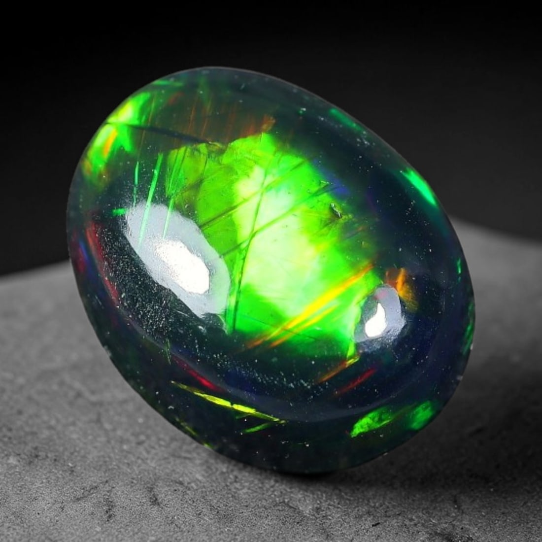 2.11ct Natural Ethiopian Welo Black Smoked Opal Cabochon Loose Gemstone, 5FX: This fully polished Ethiopian Welo opal features a dark smoked base with vivid, sweeping play-of-color shifting across its glossy dome surface, measured at 10x8x4mm. The black smoke treatment deepens 
