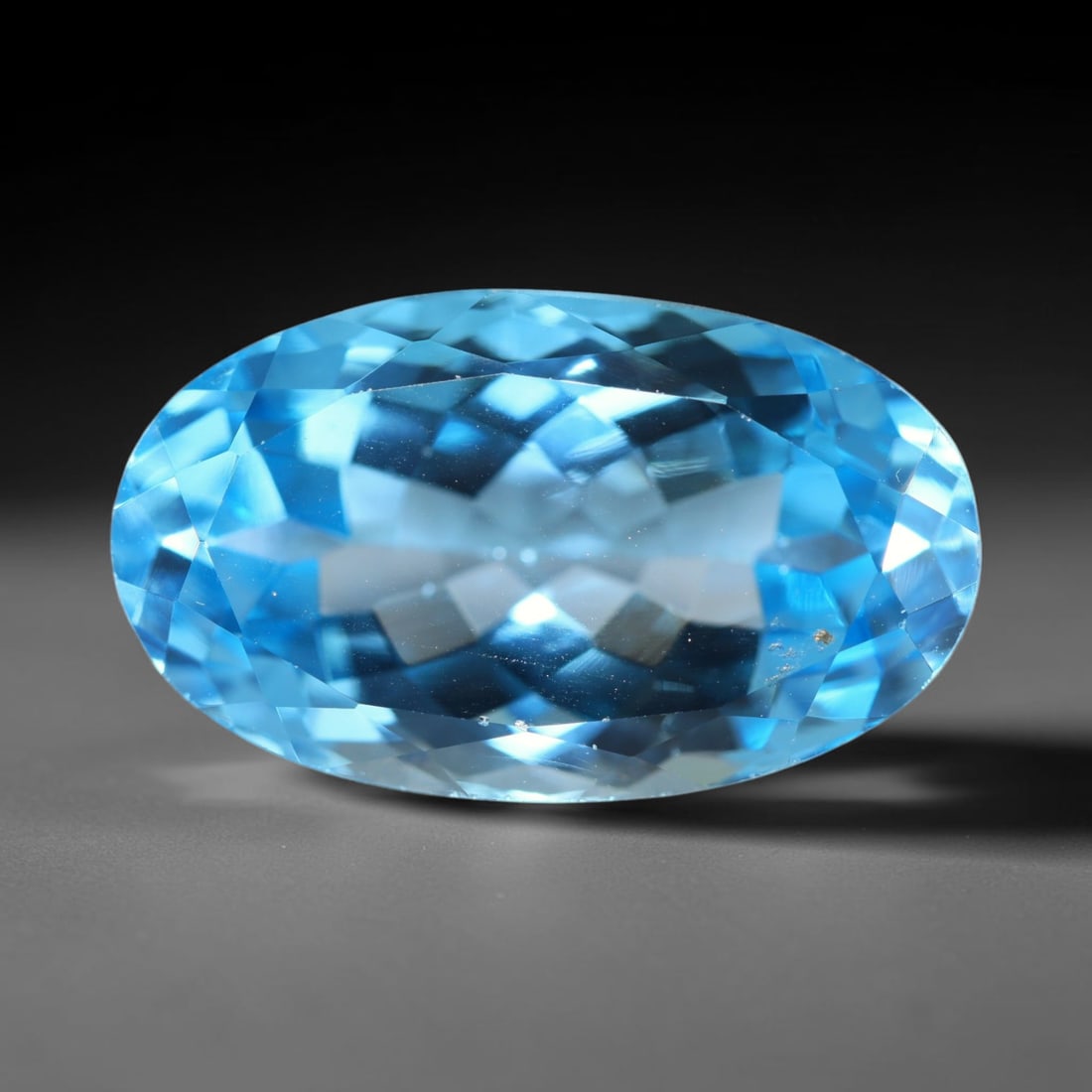 16.87ct Natural Brazilian London Blue Topaz Oval Faceted Loose Gemstone, 90BZ: This precisely cut oval faceted gemstone is natural London Blue Topaz originating from Brazil. The stone showcases an intense, rich deep royal blue hue, complemented by crisp, symmetrical faceting tha