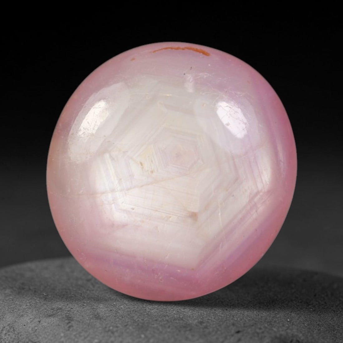 6.37ct Natural Mozambican Soft Bubblegum Pink Ruby Cabochon Loose Gemstone, 92AR: This smoothly polished domed ruby cabochon displays a gentle soft bubblegum pink body tone with faint natural linear mineral veining and tiny scattered rust-hued mineral flecks embedded within its tra
