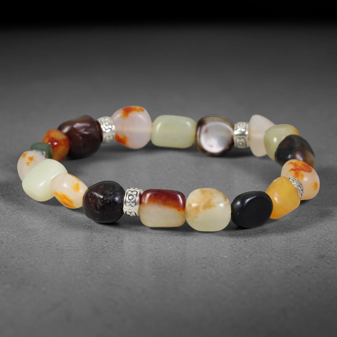 Natural Chinese Hetian Nephrite Jade Tumbled Beaded Bracelet, 35FJ: Features polished natural Chinese Hetian nephrite jade freeform tumbled beads paired with decorative accent elements. Approximate bead size 7mm, arranged into a flexible wearable strand. Each bead car