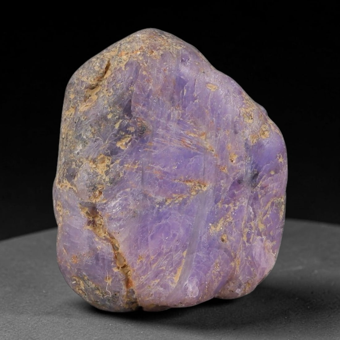 28.93ct Natural Unheated Sri Lankan Purplish Blue Sapphire Rough, 66FC: This natural corundum rough is an unheated purplish blue sapphire sourced from Sri Lankan alluvial gem deposits, featuring an irregular natural native form with residual pale yellow-brown mineral matr