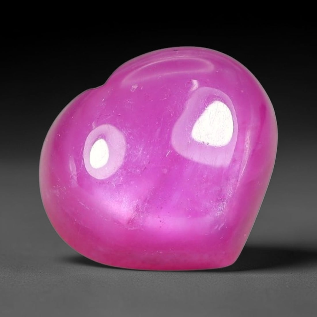 6.41 Carats Natural Mozambique Hot Pink Ruby Loose Gemstone, 47FE: This heart shaped Mozambique ruby cabochon measures 10.8x9.6x5.4mm, showcasing a vivid saturated hot pink body paired with stunning natural hexagonal crystal growth banding that forms a distinct geome
