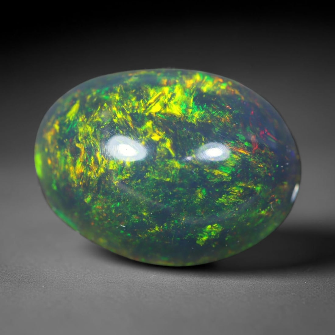1.91ct Natural Ethiopian Welo Black Smoked Opal Cabochon Loose Gemstone, 38FL: This fully polished Ethiopian Welo opal features a dark smoked base with vivid, sweeping play-of-color shifting across its glossy dome surface, measured at 10.2x8x5.3mm. The black smoke treatment deep