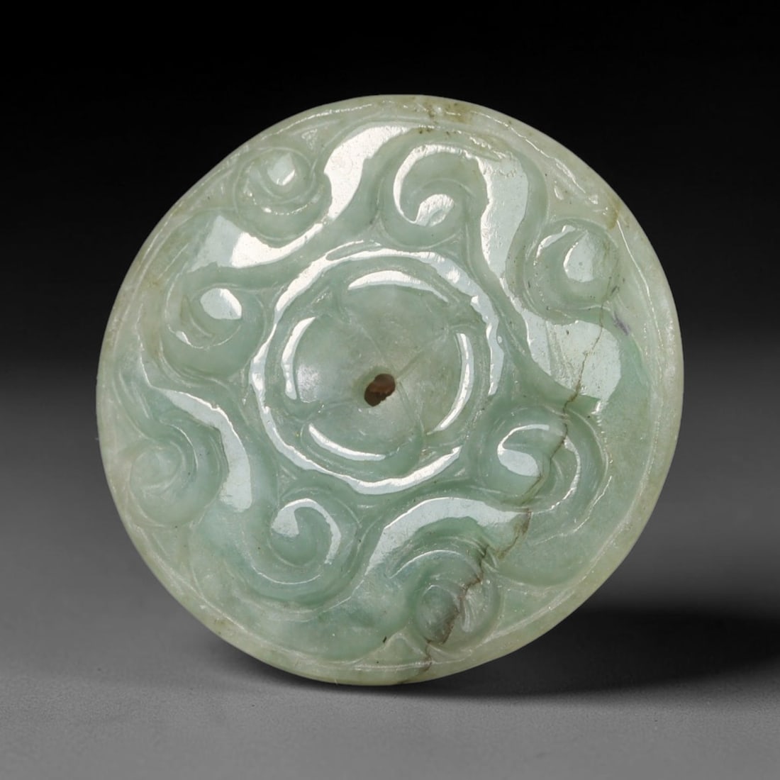 Natural Burmese Type A Jadeite Jade Carved Disc Pendant, 55BP: Artisan hand-carved untreated Burmese Type A jadeite jade circular disc pendant with a 27 mm diameter. The surface is adorned with detailed traditional relief carving finished with a smooth polished s
