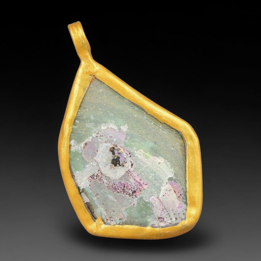 Ancient Roman Glass Slag in Modern Gilt-Edge Pendant, 68FY: This contemporary pendant is crafted from ancient Roman glass slag, featuring a fragmented, iridescent glass surface with weathered patina. The irregular form is bordered by a subtle gilt frame, added