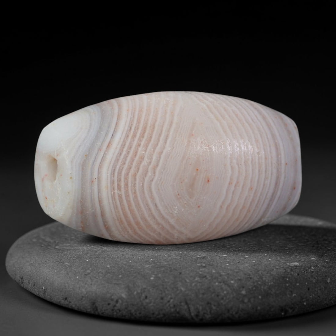 Ancient Parthian Persian Empire Fine Banded Agate Barrel Bead (247 BCE - 224 CE), 55AD: This antique banded agate barrel bead originates from the Parthian Persian Empire, a dominant Silk Road power with renowned agate lapidary workshops crafting ritual talismans and elite jewelry for exc