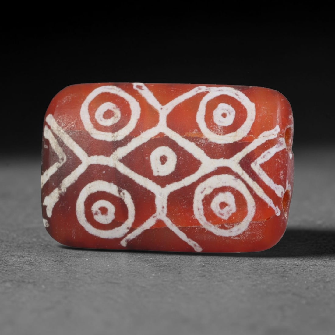 Antique Sino-Himalayan Region Etched Carnelian Bead, 8EH: Antique etched carnelian bead originating from the Sino-Himalayan region. Exhibits characteristic surface patina and traditional etched white decoration. Dimensions: 19x13mm, fully pierced for suspens