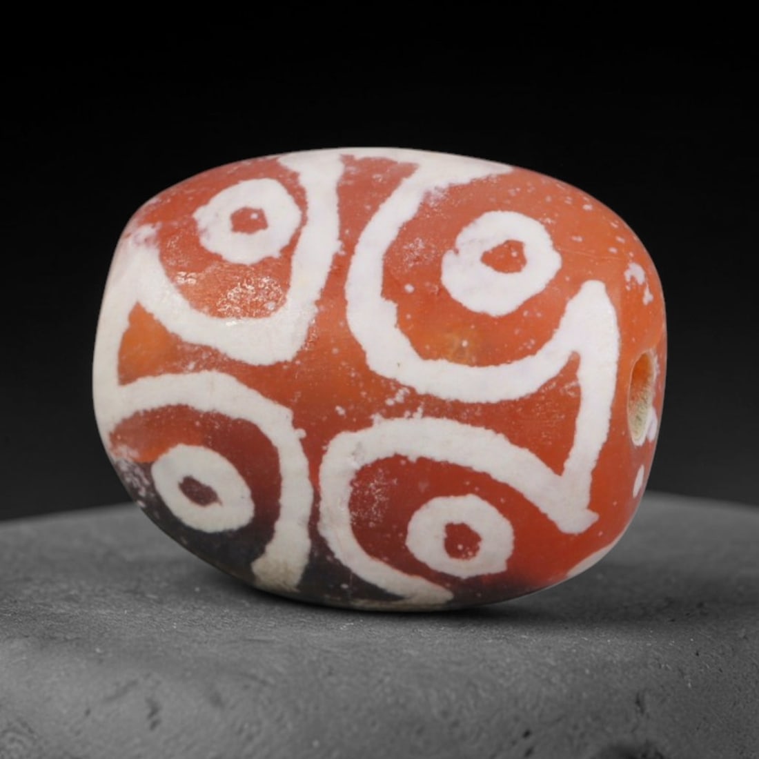 Antique Sino-Himalayan Region Etched Carnelian Bead, 6EH: Antique etched carnelian bead originating from the Sino-Himalayan region. Exhibits characteristic surface patina and traditional etched white decoration. Dimensions: 12x10mm, fully pierced for suspens