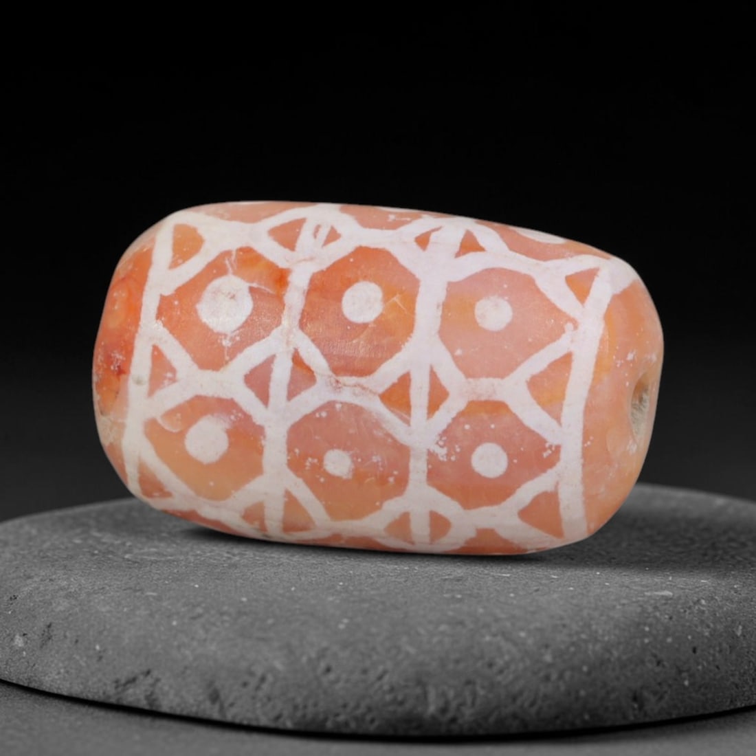 Antique Sino-Himalayan Region Etched Carnelian Bead, 18EH: Antique etched carnelian bead originating from the Sino-Himalayan region. Exhibits characteristic surface patina and traditional etched white decoration. Dimensions: 16x9mm, fully pierced for suspensi
