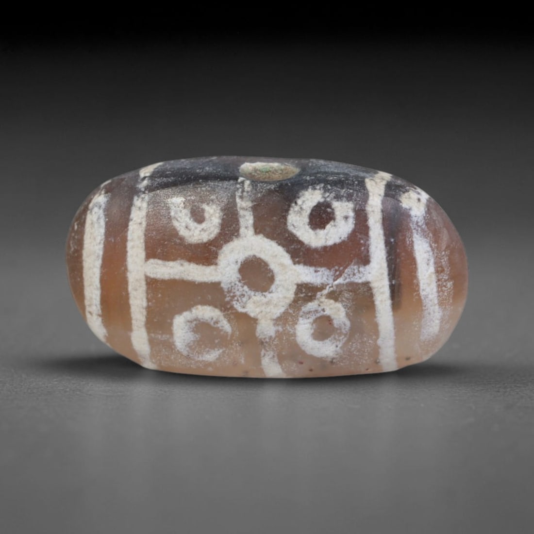 Antique Sino-Himalayan Region Etched Carnelian Bead, 81EG: Antique etched carnelian bead originating from the Sino-Himalayan region. Exhibits characteristic surface patina and traditional etched white decoration. Dimensions: 17x9mm, fully pierced for suspensi