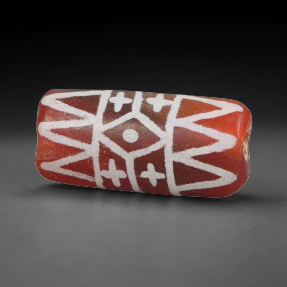 Antique Sino-Himalayan Region Etched Carnelian Bead, 76EG: Antique etched carnelian bead originating from the Sino-Himalayan region. Exhibits characteristic surface patina and traditional etched white decoration. Dimensions: 18x8mm, fully pierced for suspensi