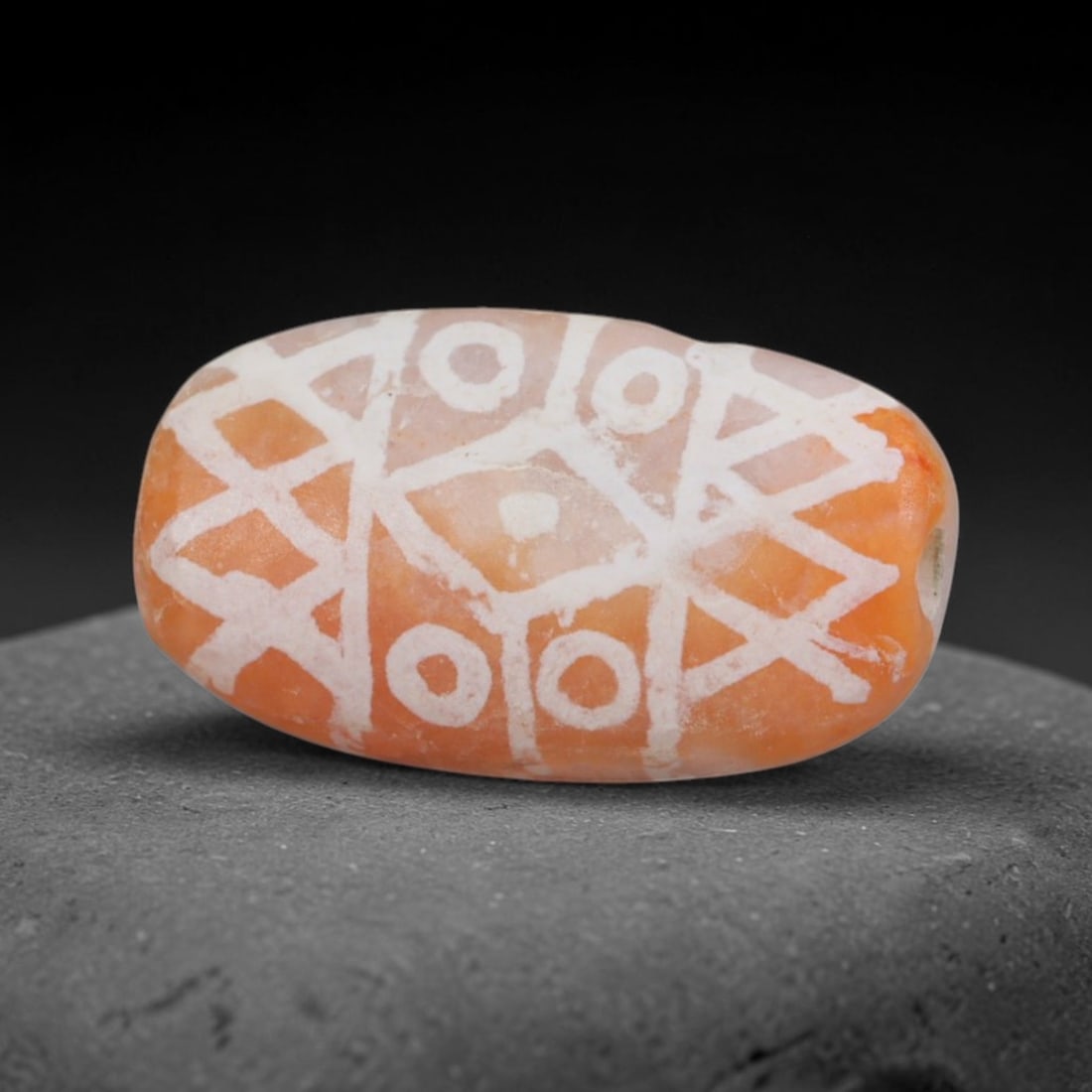 Antique Sino-Himalayan Region Etched Carnelian Bead, 82EG: Antique etched carnelian bead originating from the Sino-Himalayan region. Exhibits characteristic surface patina and traditional etched white decoration. Dimensions: 15x8mm, fully pierced for suspensi