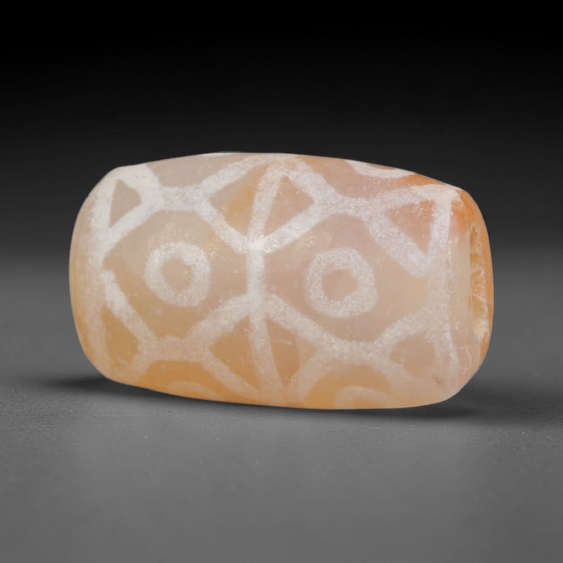 Antique Sino-Himalayan Region Etched Carnelian Bead, 80EG: Antique etched carnelian bead originating from the Sino-Himalayan region. Exhibits characteristic surface patina and traditional etched white decoration. Dimensions: 13x8mm, fully pierced for suspensi