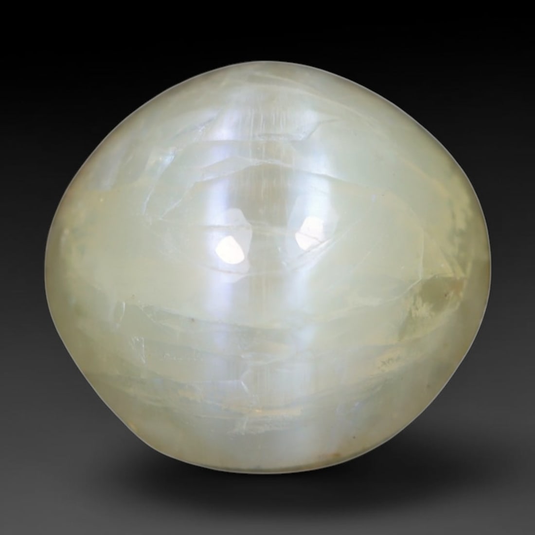 1.50 Carats Natural Ceylon Chrysoberyl Cat's Eye Loose Gemstone, 97AK: This polished Ceylon chrysoberyl cabochon displays a sharp, distinct silvery chatoyant band running across its smooth surface, formed by dense aligned microscopic rutile inclusions inherent to genuine