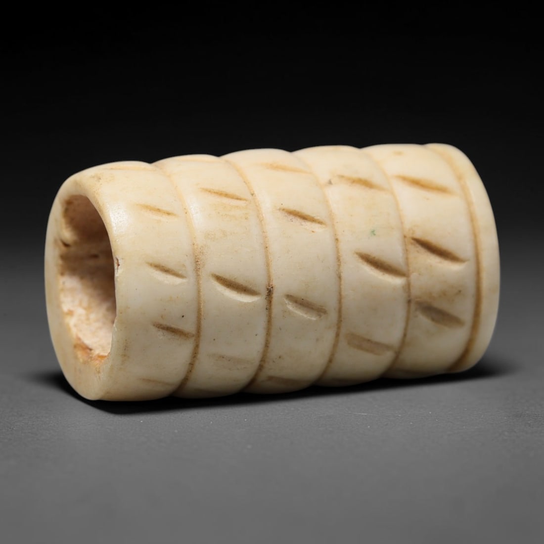 Antique Sino-Siberian Steppe Nomadic Craft Stag Antler Carved Cylinder Bead (Post 1850s), 68FV: Single bead carved from natural stag antler, originating from Sino-Siberian Steppe Nomadic craft traditions, post 1850s. Measuring 3x2cm, the piece features detailed surface carving and carries warm n