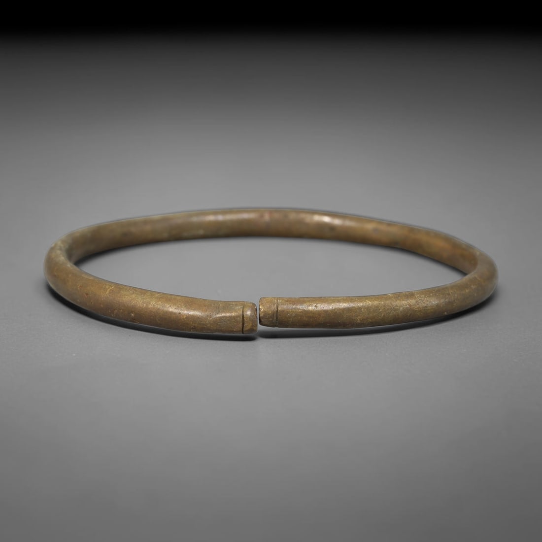 Ancient Roman Republic & Imperial Roman Bronze Open Armilla Bracelet (509 BCE-476 CE), 10AC: This antique solid bronze open cuff armilla bracelet originates from Roman Republic & Imperial Roman Culture, widely produced utilitarian and symbolic adornment worn by civilian women and awarded as m