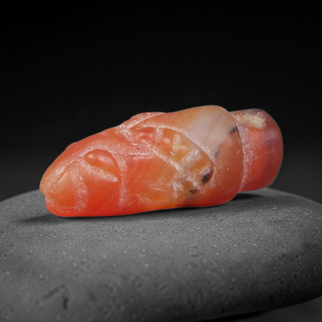 Ancient Sasanian Persian Agate Ram Head Amulet Bead (224-651 CE), 45EC: This antique ram head amulet bead carved from natural agate originates from the Sasanian Persian Empire. Ram motifs stood as powerful symbols of fertility, strength and divine protection within ancien