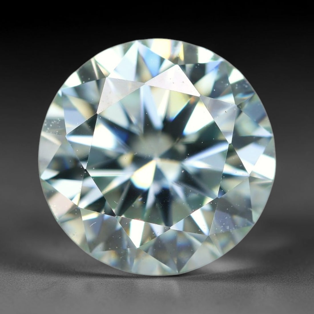 2.58 Carats Natural Cool White Moissanite Loose Gemstone, 10FL: This cool white moissanite holds dimension measurements of 9x5.4mm, delivering exceptional light dispersion that generates vivid rainbow sparkle across its fully transparent body, with faint microscop