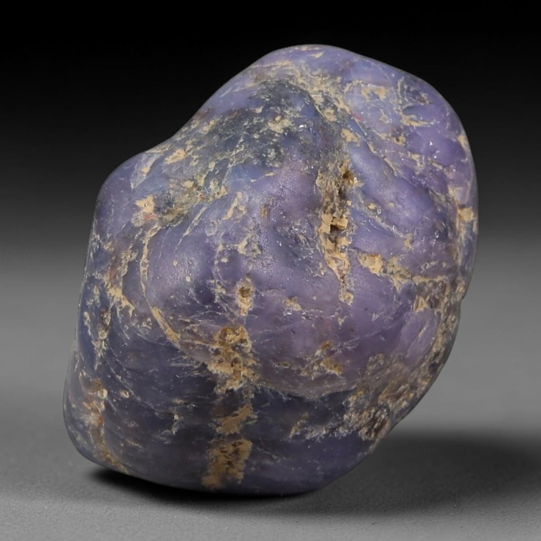 38.12ct Natural Unheated Sri Lankan Purplish Blue Sapphire Rough, 71FC: This natural corundum rough is an unheated purplish blue sapphire sourced from Sri Lankan alluvial gem deposits, featuring an irregular natural native form with residual pale yellow-brown mineral matr