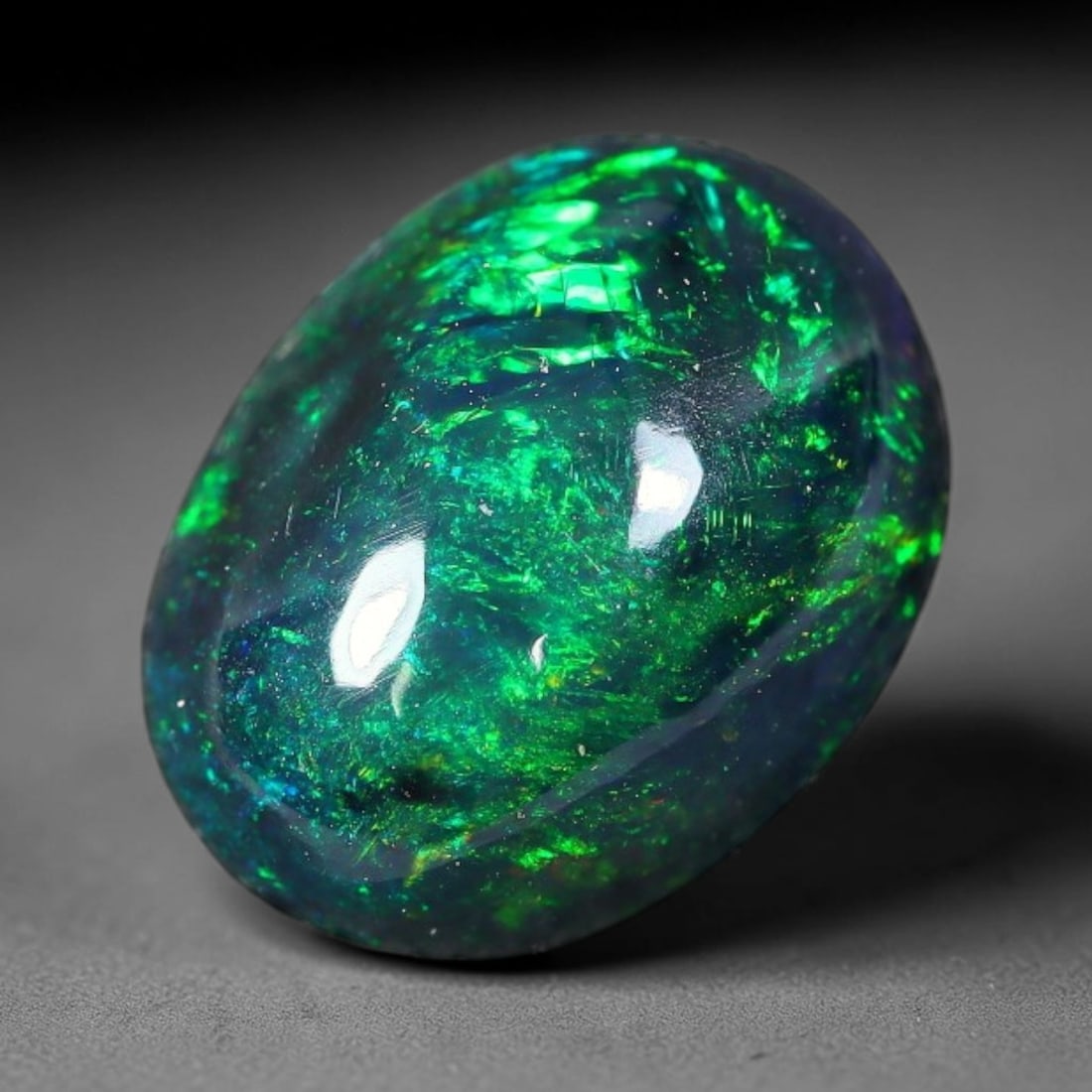 2.32ct Natural Ethiopian Welo Black Smoked Opal Cabochon Loose Gemstone, 81FX: This fully polished Ethiopian Welo opal features a dark smoked base with vivid, sweeping play-of-color shifting across its glossy dome surface, measured at 10x8x5mm. The black smoke treatment deepens 