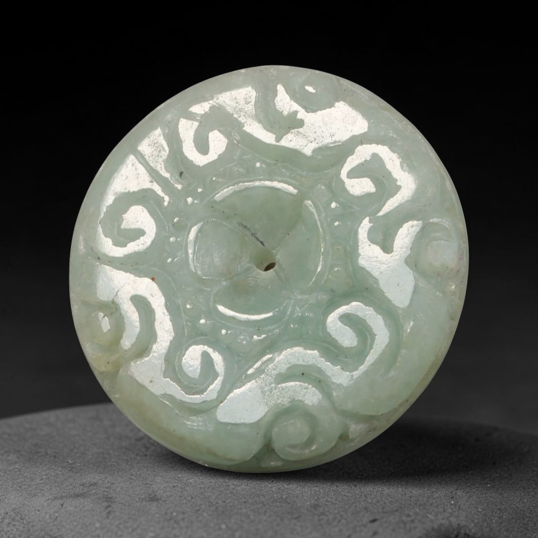 Natural Burmese Type A Jadeite Jade Carved Disc Pendant, 33BP: Artisan hand-carved untreated Burmese Type A jadeite jade circular disc pendant with a 27 mm diameter. The surface is adorned with detailed traditional relief carving finished with a smooth polished s