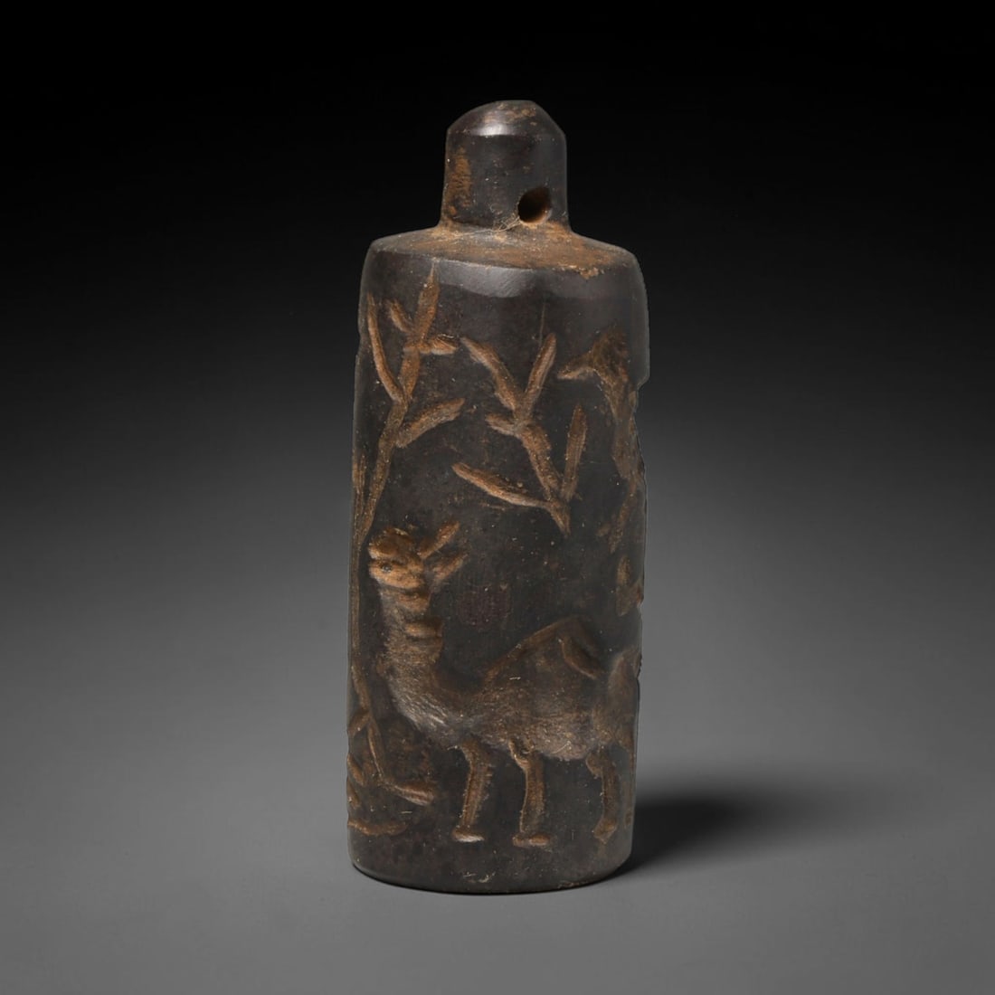 Ancient Sasanian Persian Stone Cylinder Seal (224-651 CE), 68ED: This antique stone cylinder seal originates from the Sasanian Persian Empire, utilised for rolling impressions onto clay as authentication and worn as a portable talisman. The dark stone surface bears