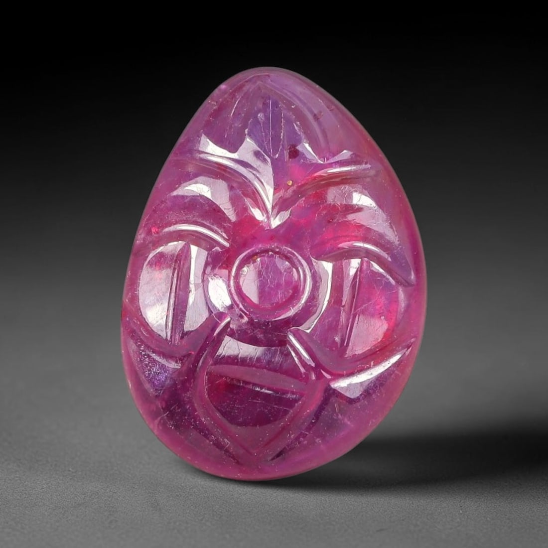 9.50 Carats Natural Mozambique Rich Fuchsia Ruby Loose Gemstone, 46FE: This natural Mozambique ruby cabochon measures 15.5x11.2x4.4mm and features delicate hand engraved floral detailing carved across its polished surface, with a rich saturated fuchsia hue spread evenly 