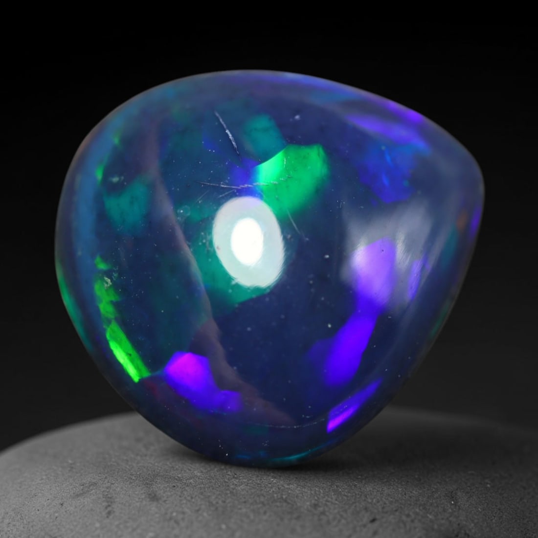 4.14ct Natural Ethiopian Welo Black Smoked Opal Cabochon Loose Gemstone, 73BY: This fully polished Ethiopian Welo opal features a dark smoked base with vivid, sweeping play-of-color shifting across its glossy dome surface, measured at 13x12x6mm. The black smoke treatment deepens