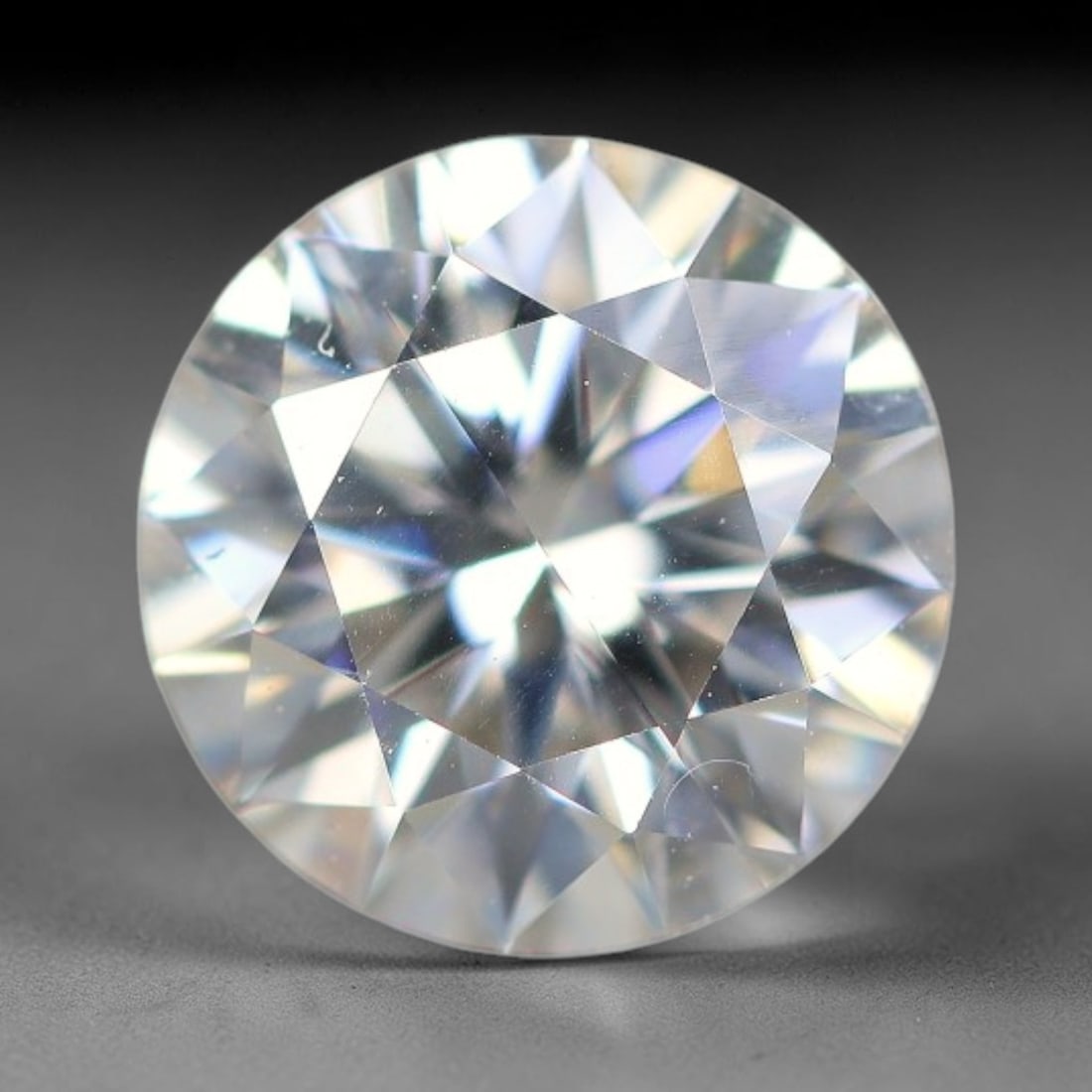 1.21 Carats Natural Cool White Moissanite Loose Gemstone, 83FM: This cool white moissanite holds dimension measurements of 7x4.3mm, delivering exceptional light dispersion that generates vivid rainbow sparkle across its fully transparent body, with faint microscop