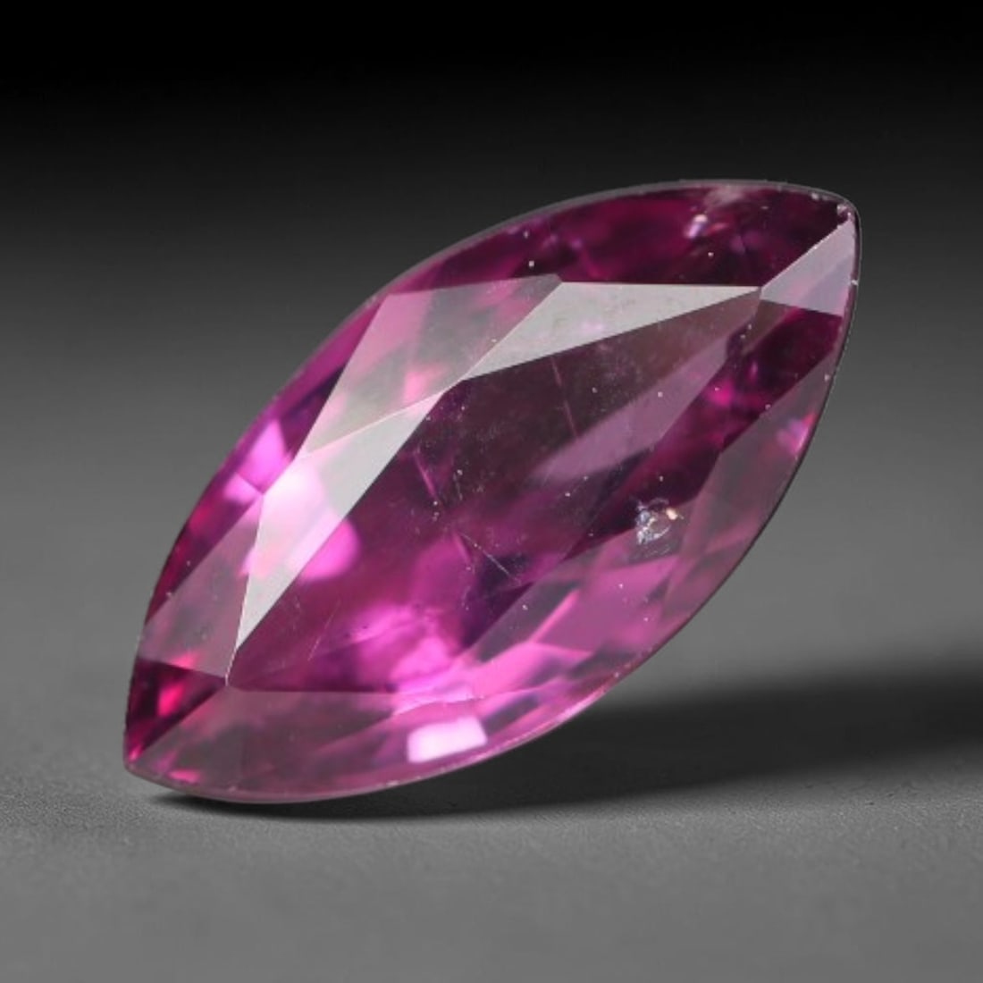 0.98ct Natural Tanzanian Rhodolite Grape Garnet Faceted Loose Gemstone, 83BA: This expertly faceted grape garnet, a scarce saturated purple-magenta rhodolite variant, features transparent crystal structure dotted with faint microscopic mineral specks within its precisely cut re