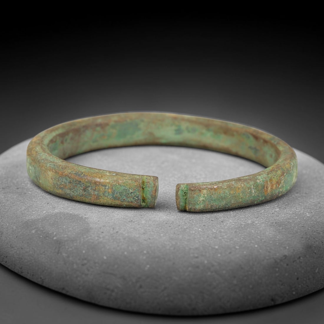 Ancient Roman Republic & Imperial Roman Bronze Open Armilla Bracelet (509 BCE-476 CE), 8AC: This antique solid bronze open cuff armilla bracelet originates from Roman Republic & Imperial Roman Culture, widely produced utilitarian and symbolic adornment worn by civilian women and awarded as m