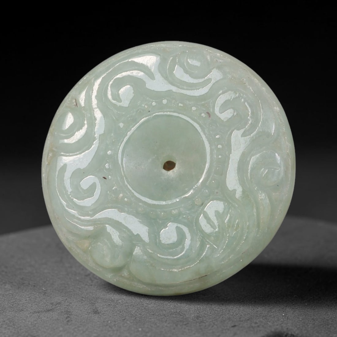Natural Burmese Type A Jadeite Jade Carved Disc Pendant, 51BP: Artisan hand-carved untreated Burmese Type A jadeite jade circular disc pendant with a 26 mm diameter. The surface is adorned with detailed traditional relief carving finished with a smooth polished s