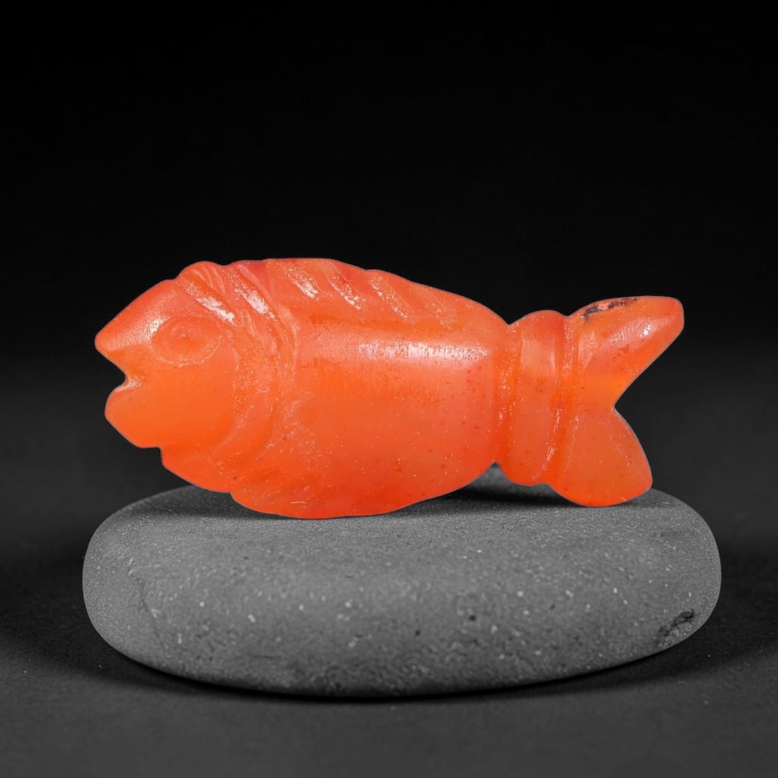 Ancient Babylonian & Kassite Cultures Carnelian Fish Amulet (1900-600 BCE), 52FV: This carved carnelian fish amulet originates from Babylonian & Kassite Cultures of the ancient Near East, where zoomorphic carnelian talismans represented abundance, fertility and aquatic divine prote