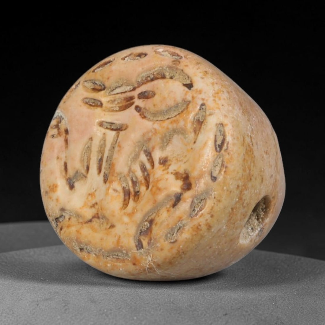 Ancient Sasanian Persian Conoid Stamp Seal (c.224-651 CE), 81ED: This pale weathered stone conoid stamp seal originates from Ancient Sasanian Persian culture. The rounded sealing face bears deeply incised figural motifs executed in characteristic regional carving s