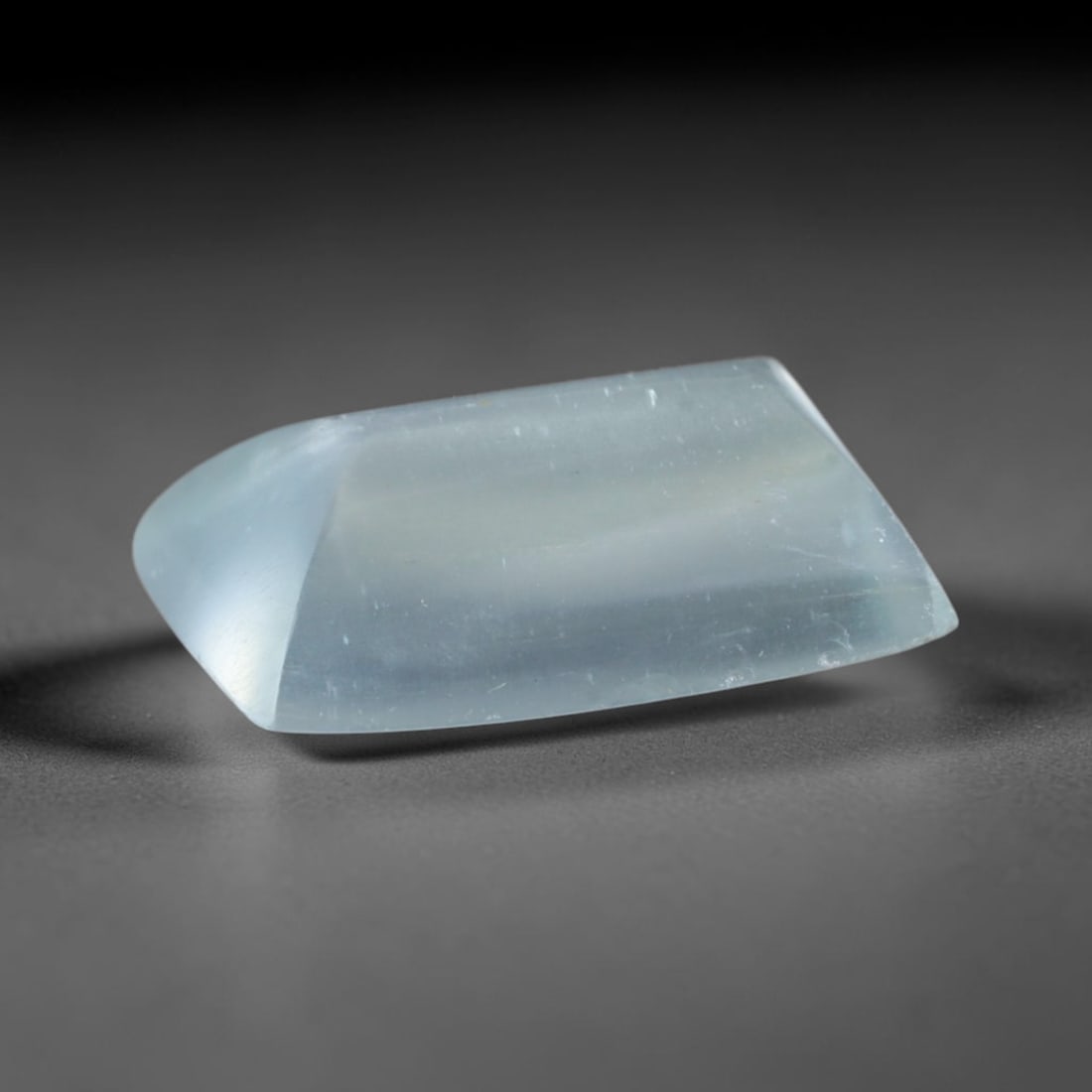 2.37 Carats Natural Brazilian Sky Blue Sugarloaf Aquamarine Loose Gemstone, 65AG: This smooth sugarloaf aquamarine features soft milky sky blue coloring with fine natural fibrous internal inclusions that lend gentle diffused luster across its polished surface, measured at 10.6x7.8x