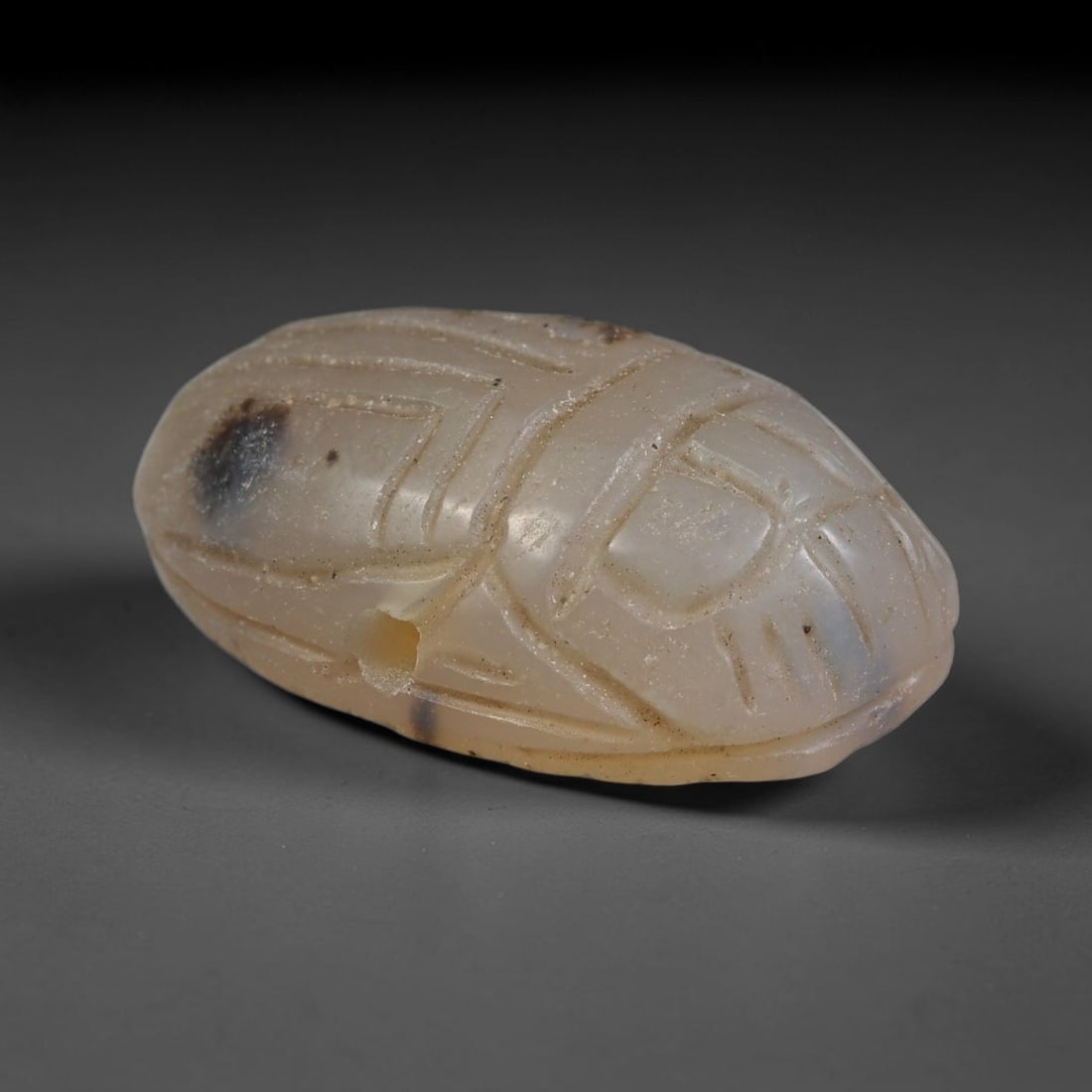 Ancient Pharaonic Egyptian Agate Scarab Amulet Bead (3100 BCE-30 CE), 17EC: This antique scarab amulet bead is carved from natural agate, originating from Pharaonic Egyptian culture. Scarabs were sacred protective talismans closely linked to rebirth and eternal life within an