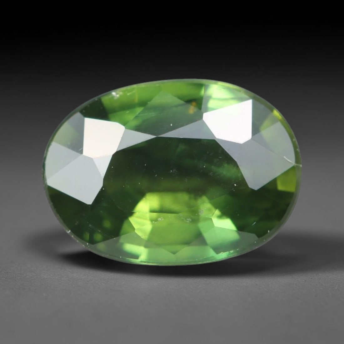 1.12ct Natural Australian Parti Sapphire Faceted Loose Gemstone, 64BA: This expertly faceted Australian parti sapphire features blended multi-tonal green-yellow internal saturation with tiny scattered microscopic mineral specks suspended within its transparent crystallin