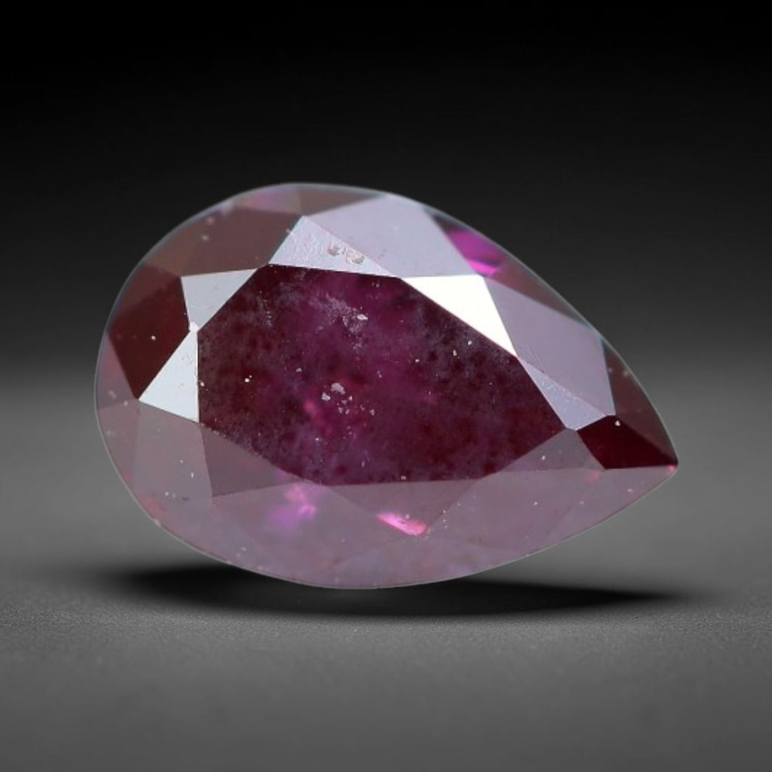 0.21ct Natural Fancy Deep Pink Diamond Loose Gemstone, 31BH: This polished natural fancy diamond features rich deep pink colouration, measured at calibrated dimensions of 4.7x3.2x1.9mm. Carefully proportioned pear faceting delivers dynamic light movement, highl