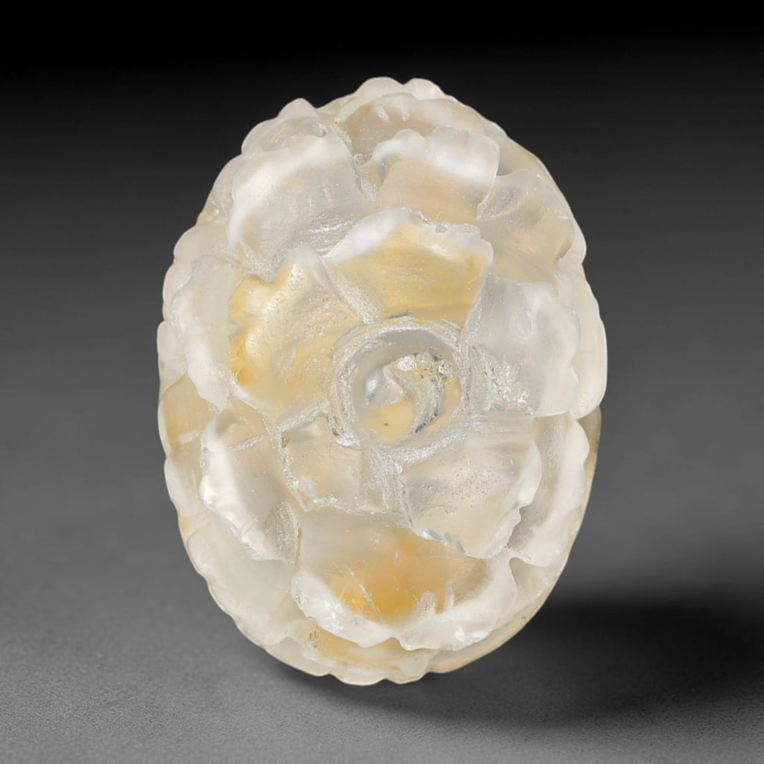 Natural Brazilian Phantom Quartz Hand Carved Floral Gemstone, 99BQ: This hand-carved floral specimen is crafted from natural phantom quartz. Intricate layered floral detailing wraps across the stone's surface, while translucent quartz matrix reveals subtle internal ph