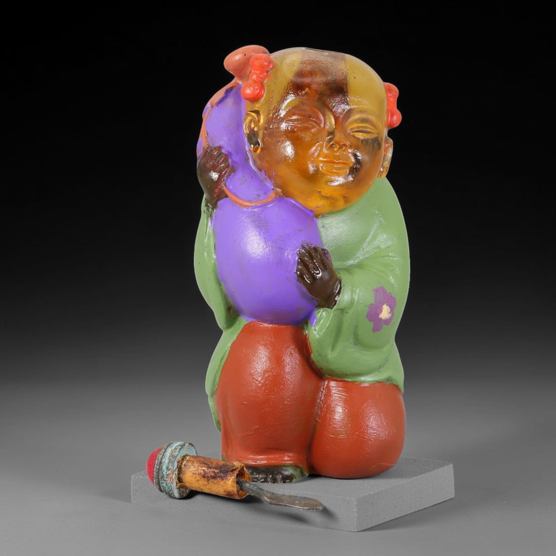 Vintage Chinese Liuli Glass Snuff Bottle - Girl with Melon, 54AS: This snuff bottle is moulded from translucent amber liuli glass, shaped as a young girl clutching a melon. The robe and fruit receive hand-painted enamel colouring with small floral accents, showing c