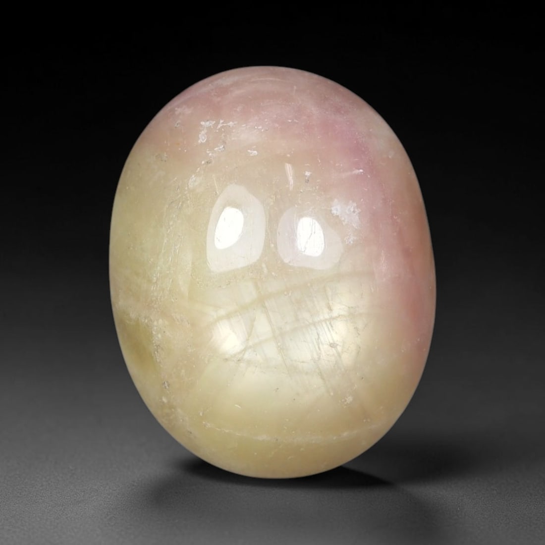 15.13 Carats Natural Madagascar Soft Rose Pink Heated Ruby Cabochon Loose Gemstone, 40FE: This warm blush-toned ruby cabochon carries blended swathes of soft rose pink and gentle peach undertones, with faint natural mineral veining throughout the polished dome, measured at 15.8x12.4x7.6mm.