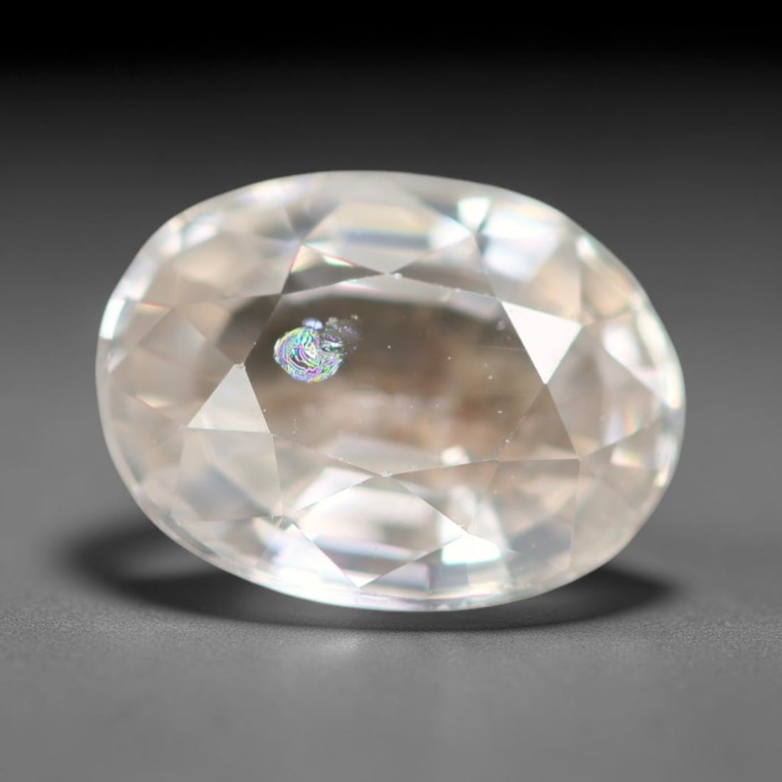 1.56ct Natural Cambodian White Zircon Loose Gemstone, 2BA: This fully polished Cambodian white zircon displays a crisp colorless transparent crystal body with faint microscopic mineral specks scattered within its high-refraction interior, measured at calibrat